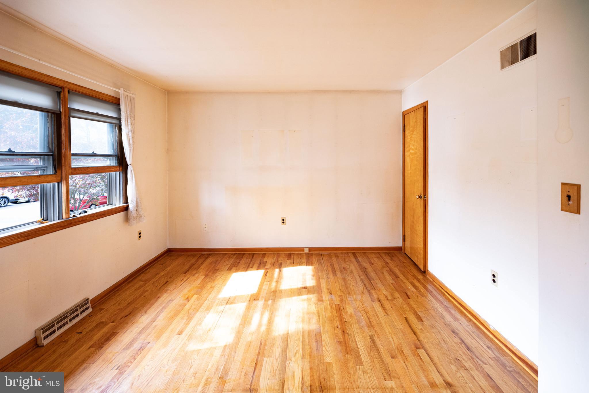 80 4th Avenue Hamilton, NJ 08619 - Photo 11 of 19 a view of an empty room with a window and wooden floor