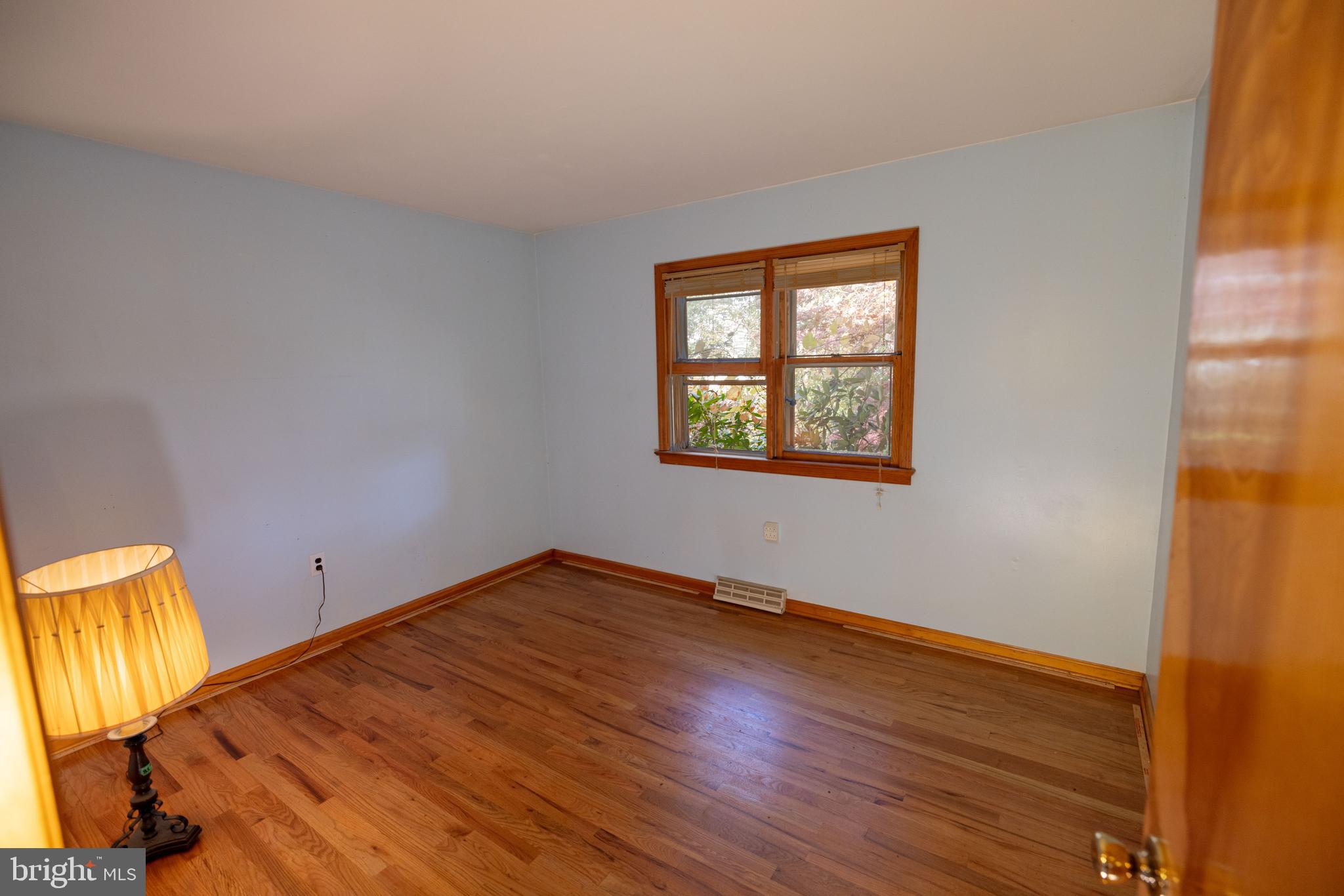 80 4th Avenue Hamilton, NJ 08619 - Photo 13 of 19 a view of an empty room with wooden floor and a window