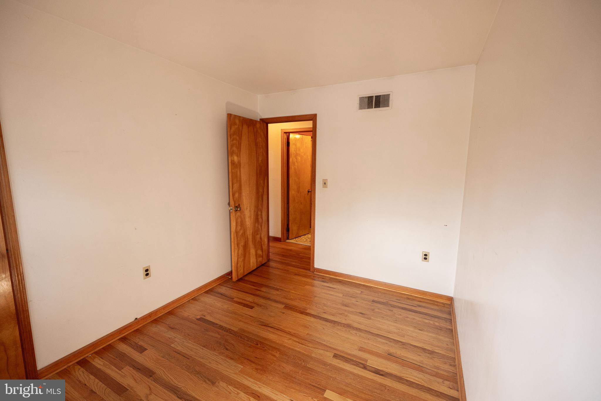 80 4th Avenue Hamilton, NJ 08619 - Photo 16 of 19 a view of an empty room with wooden floor
