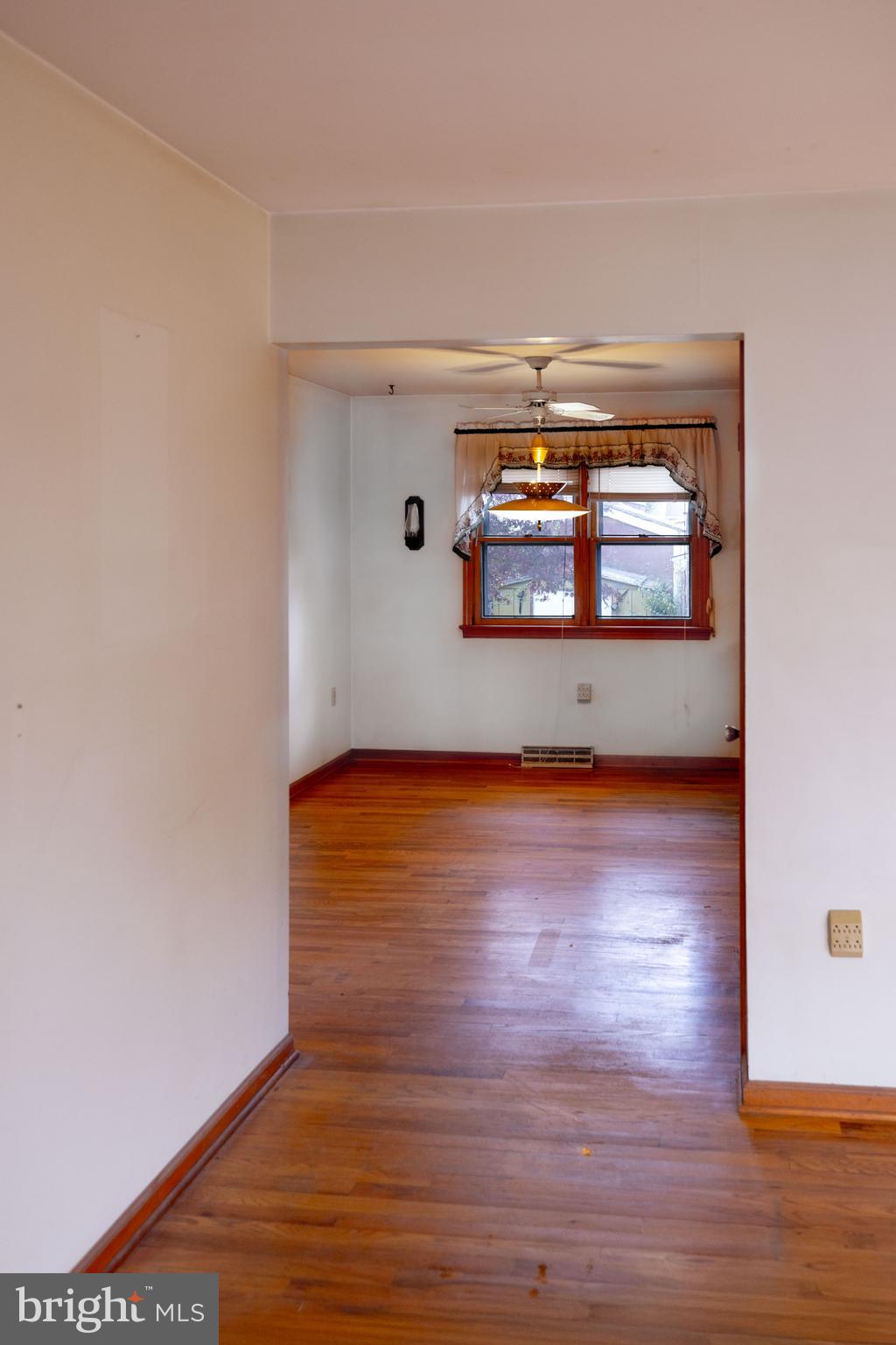 80 4th Avenue Hamilton, NJ 08619 - Photo 3 of 19 an empty room with wooden floor and window