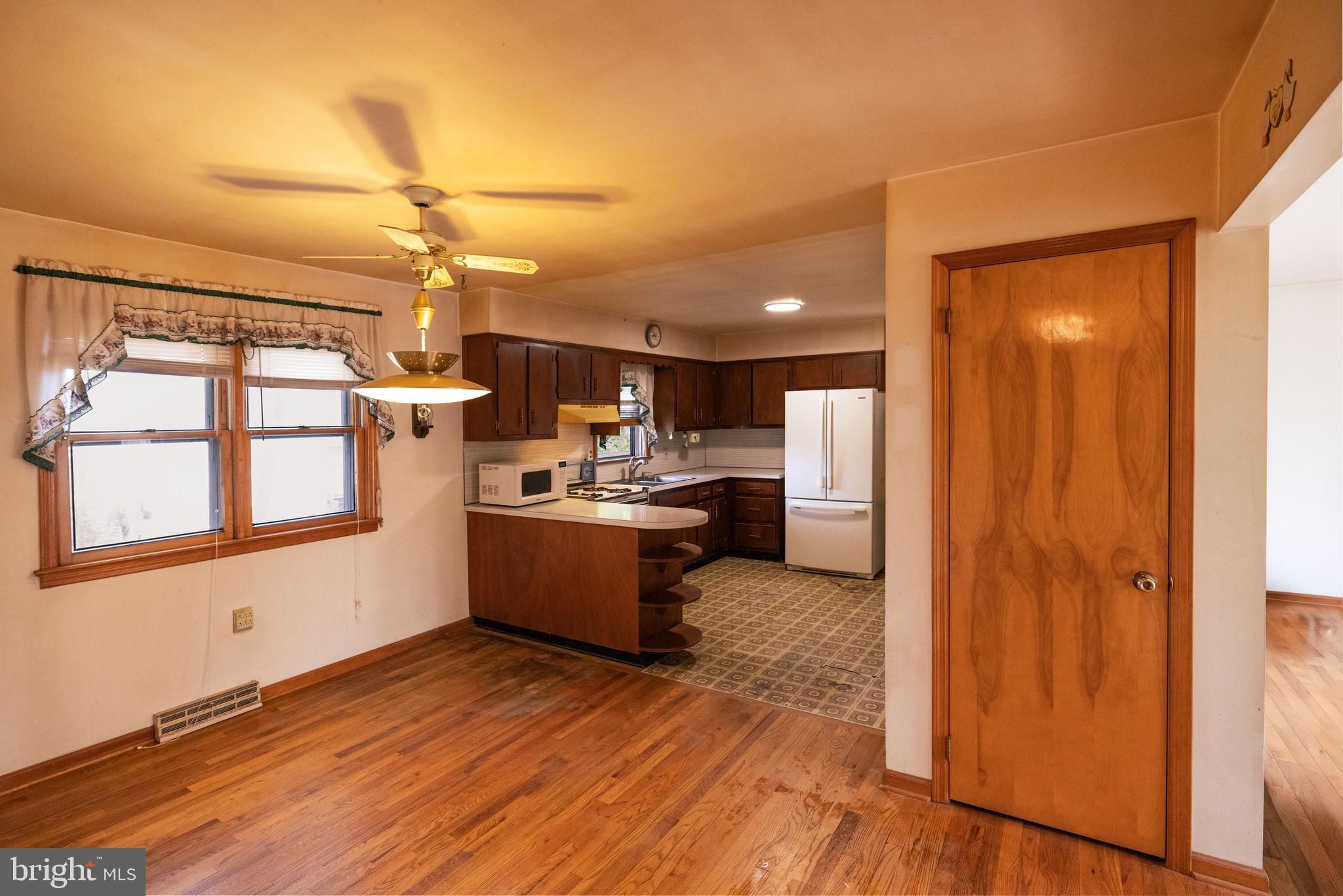 80 4th Avenue Hamilton, NJ 08619 - Photo 4 of 19 a view of a kitchen with a refrigerator and windows