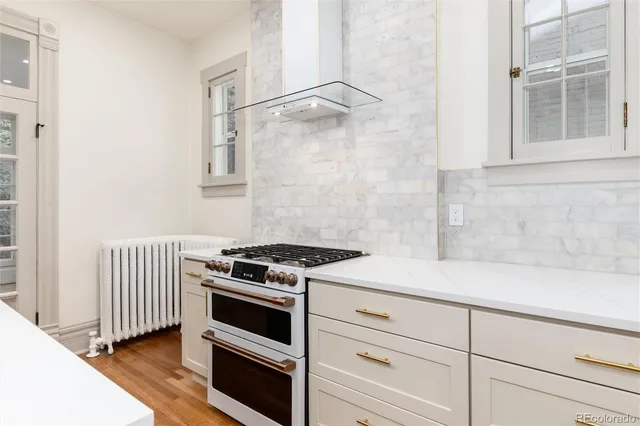 a kitchen with white cabinets and white appliances