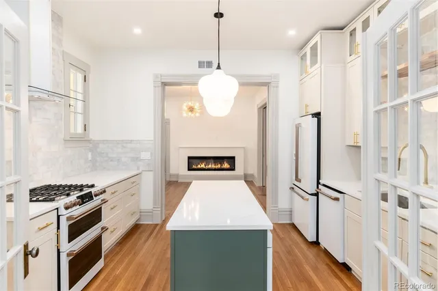 a kitchen with stainless steel appliances granite countertop a stove and a refrigerator