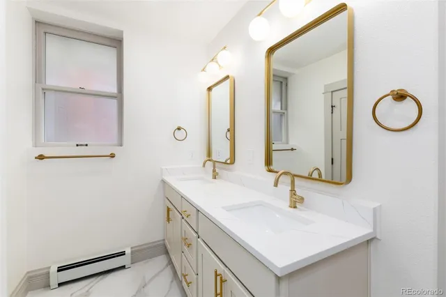 a bathroom with a sink vanity and a mirror