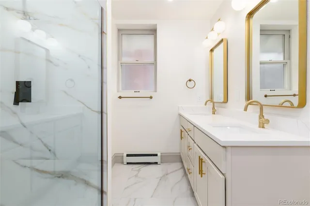 a bathroom with a double vanity sink and a mirror