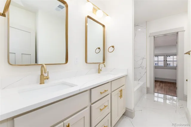 a bathroom with a double vanity sink and a mirror