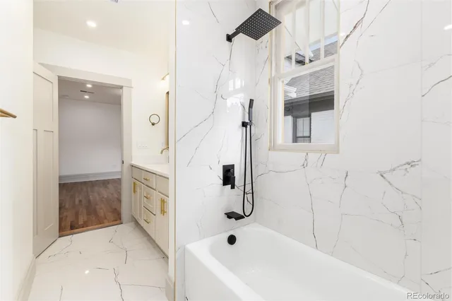a bathroom with a bathtub and shower