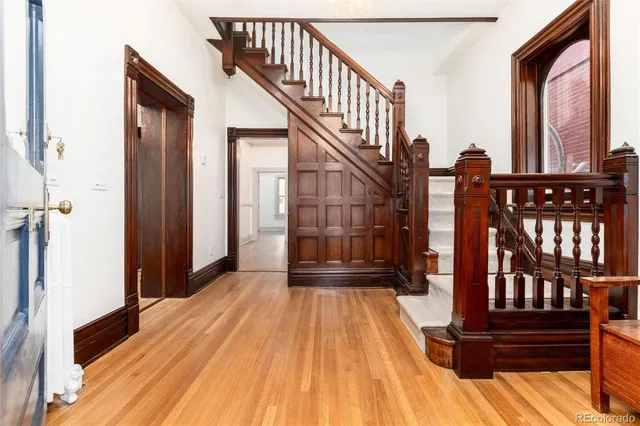 a view of entryway with wooden floor and stairs