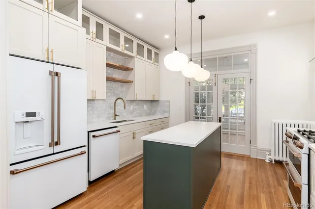 a kitchen with sink cabinets and wooden floor