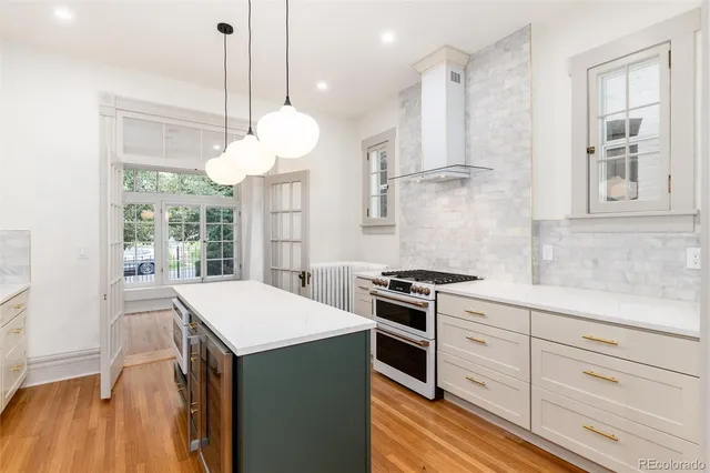 a kitchen with stainless steel appliances granite countertop a stove a sink and a refrigerator