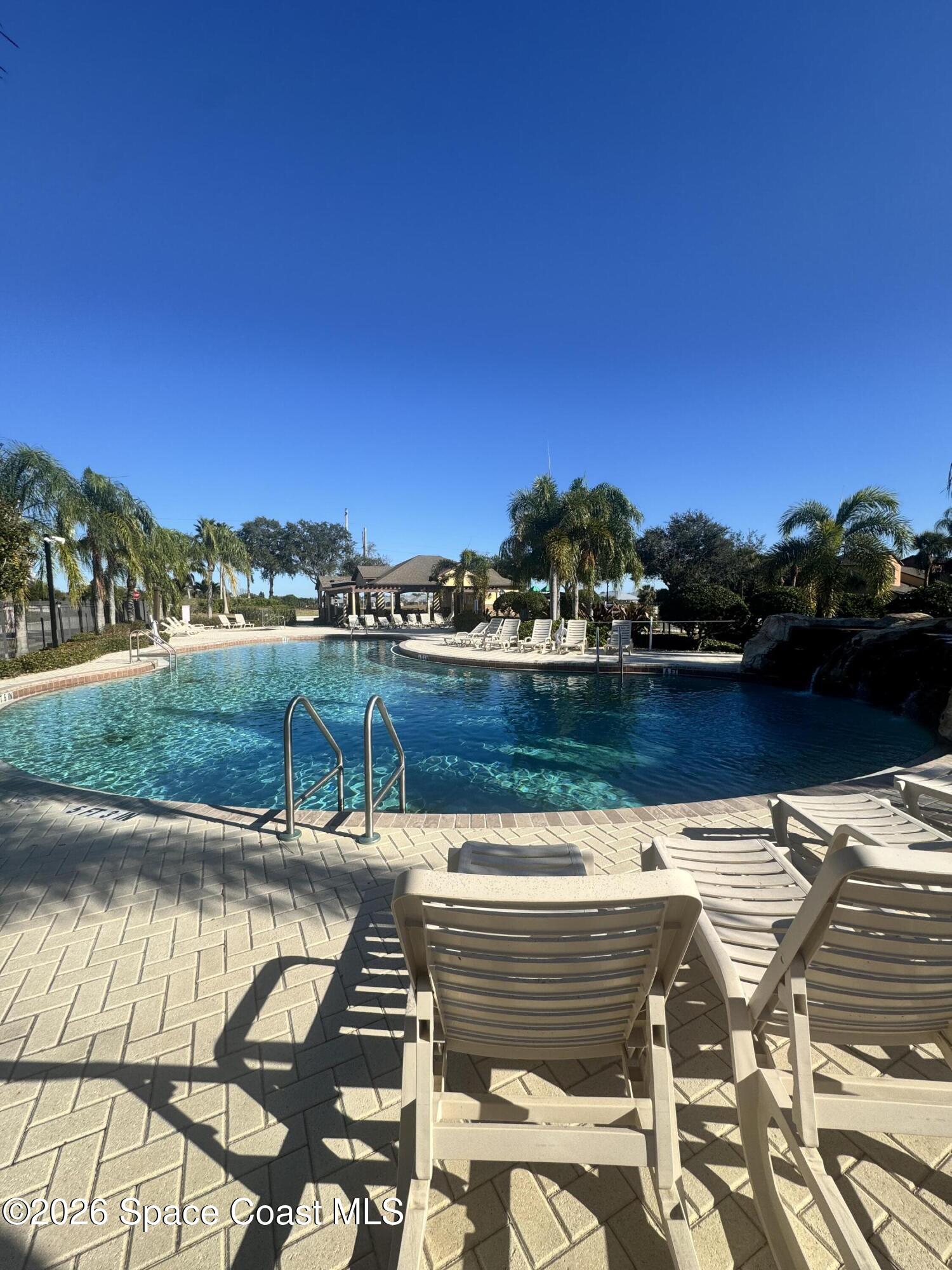 4575 Radiant Way, Unit 102 Melbourne, FL 32901 - Photo 14 of 73 a view of swimming pool with outdoor seating and plants