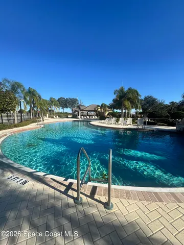 a living room with lots of furniture and a large window