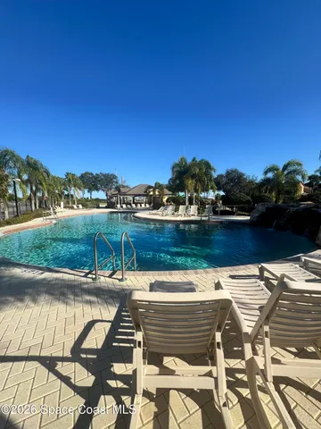 a view of a back yard with a large tree