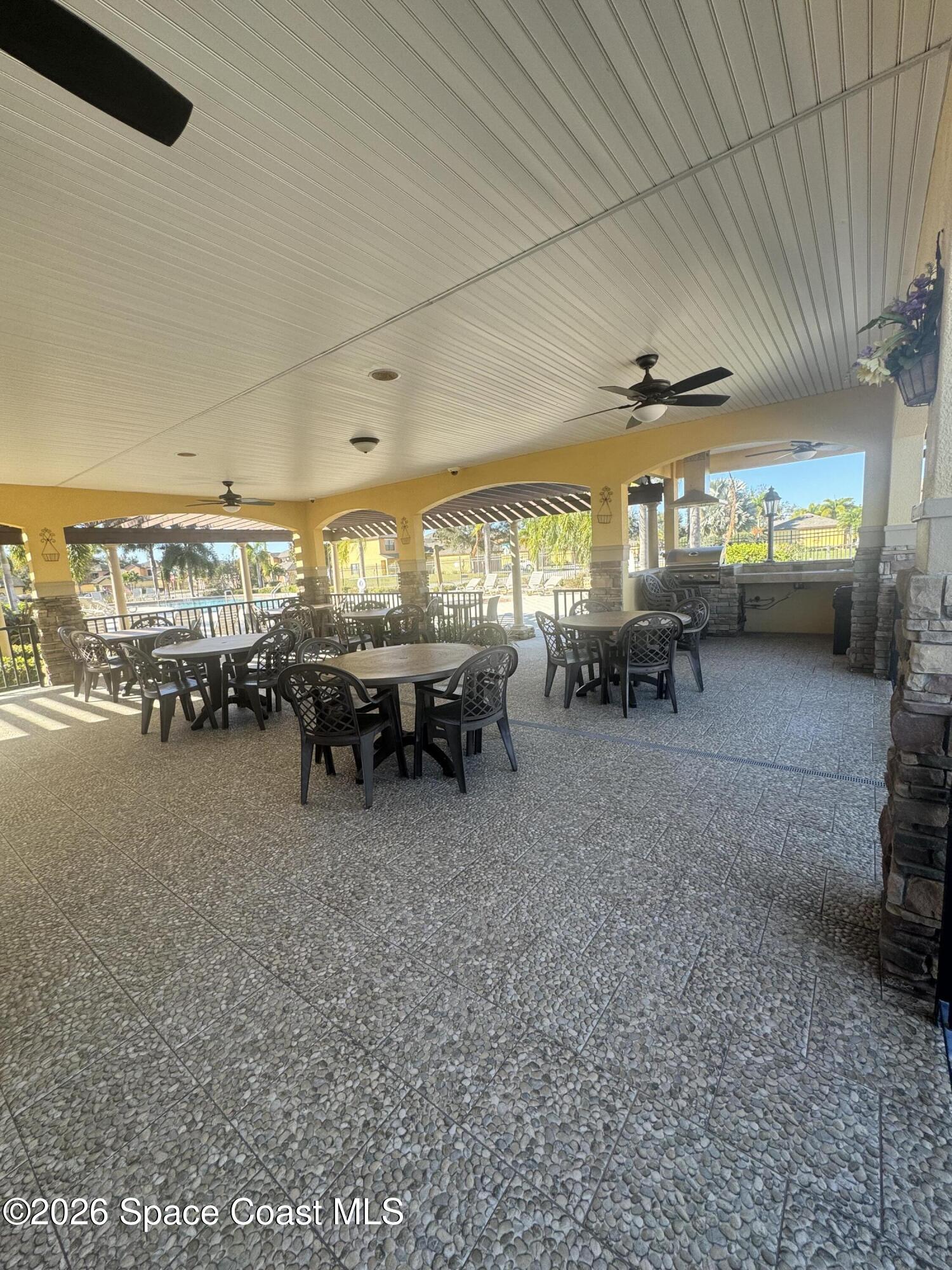 4575 Radiant Way, Unit 102 Melbourne, FL 32901 - Photo 27 of 73 a living room with lots of furniture and a large window
