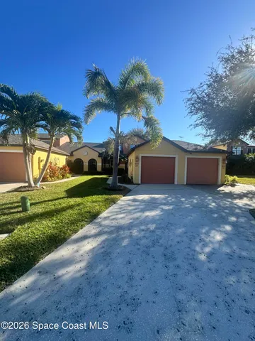 a view of a house with a yard and a garage