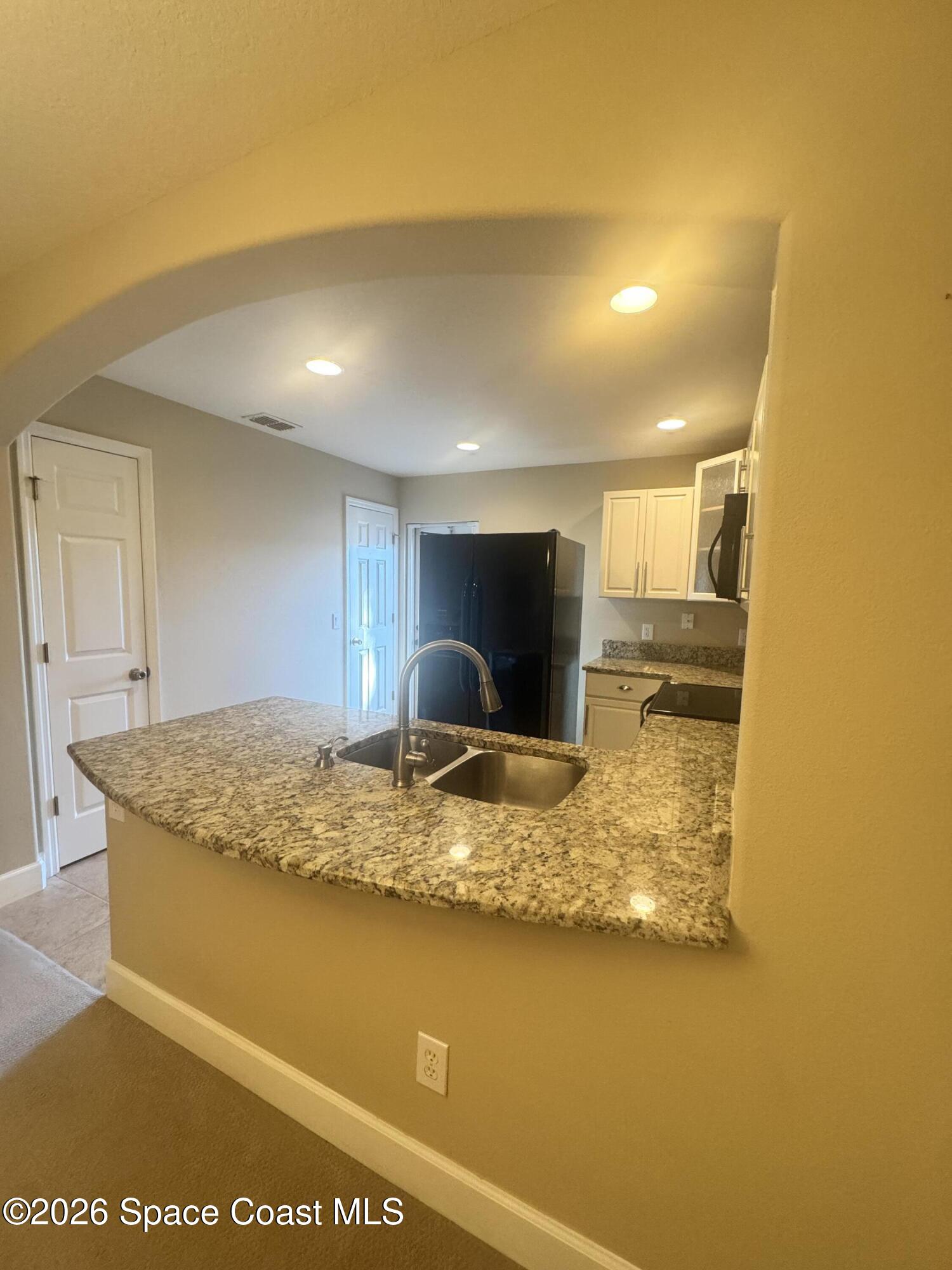 4575 Radiant Way, Unit 102 Melbourne, FL 32901 - Photo 40 of 73 a view of kitchen island with wooden floor