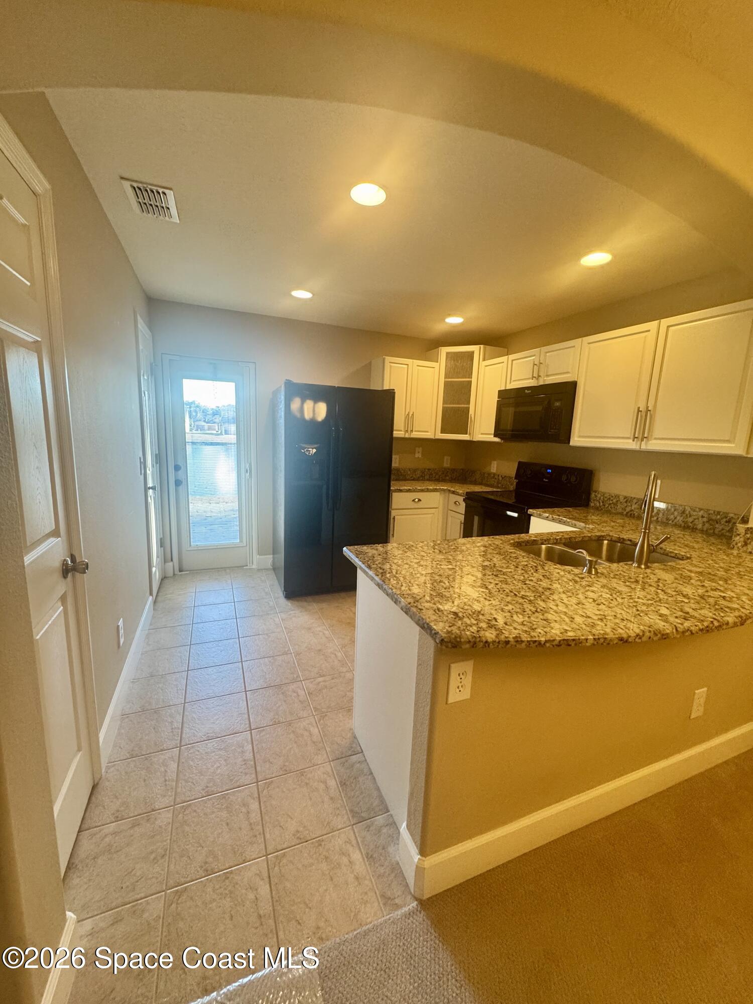 4575 Radiant Way, Unit 102 Melbourne, FL 32901 - Photo 41 of 73 a kitchen with stainless steel appliances granite countertop a sink and cabinets