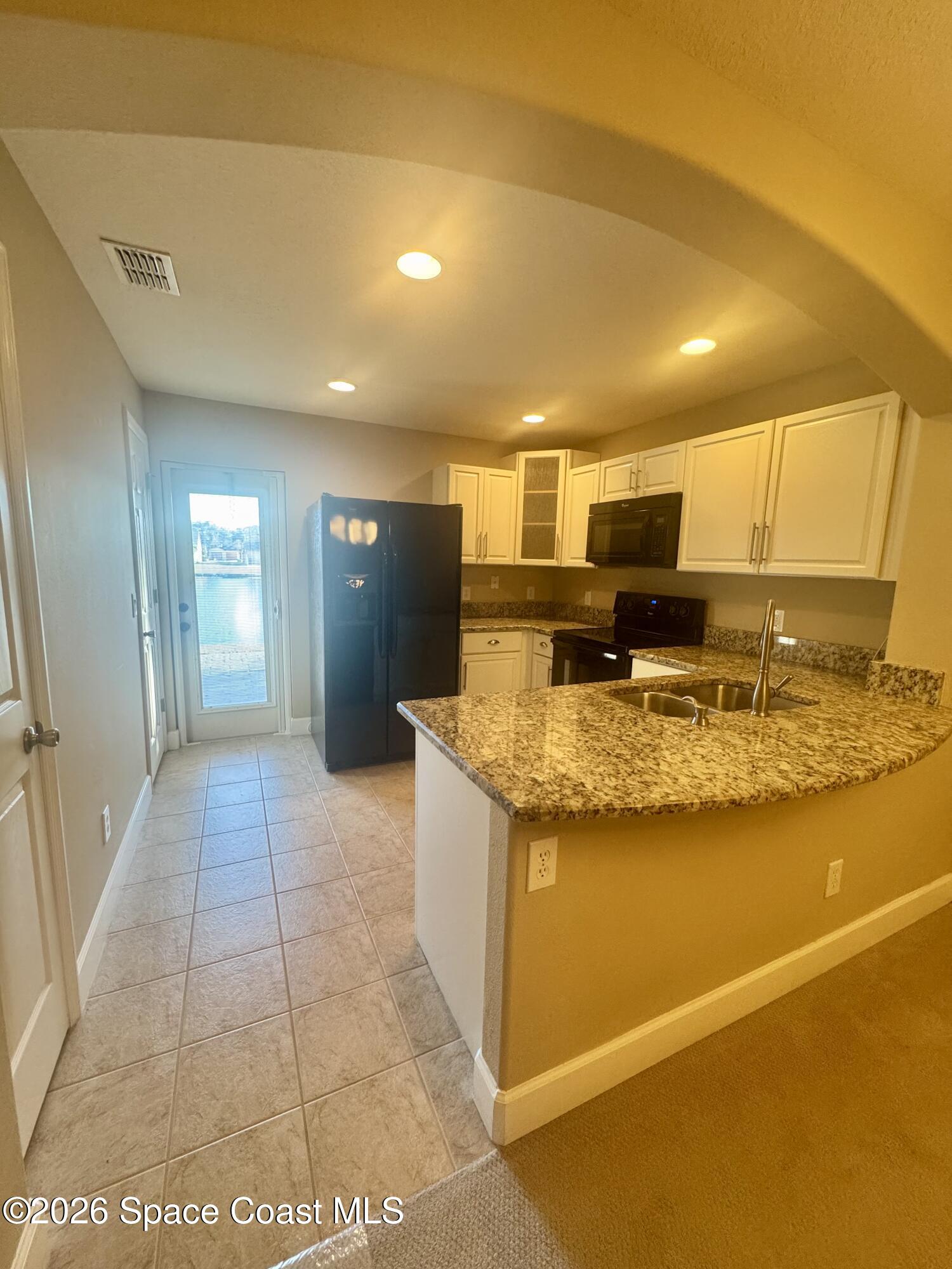 4575 Radiant Way, Unit 102 Melbourne, FL 32901 - Photo 44 of 73 a view of kitchen with stainless steel appliances granite countertop sink and cabinets