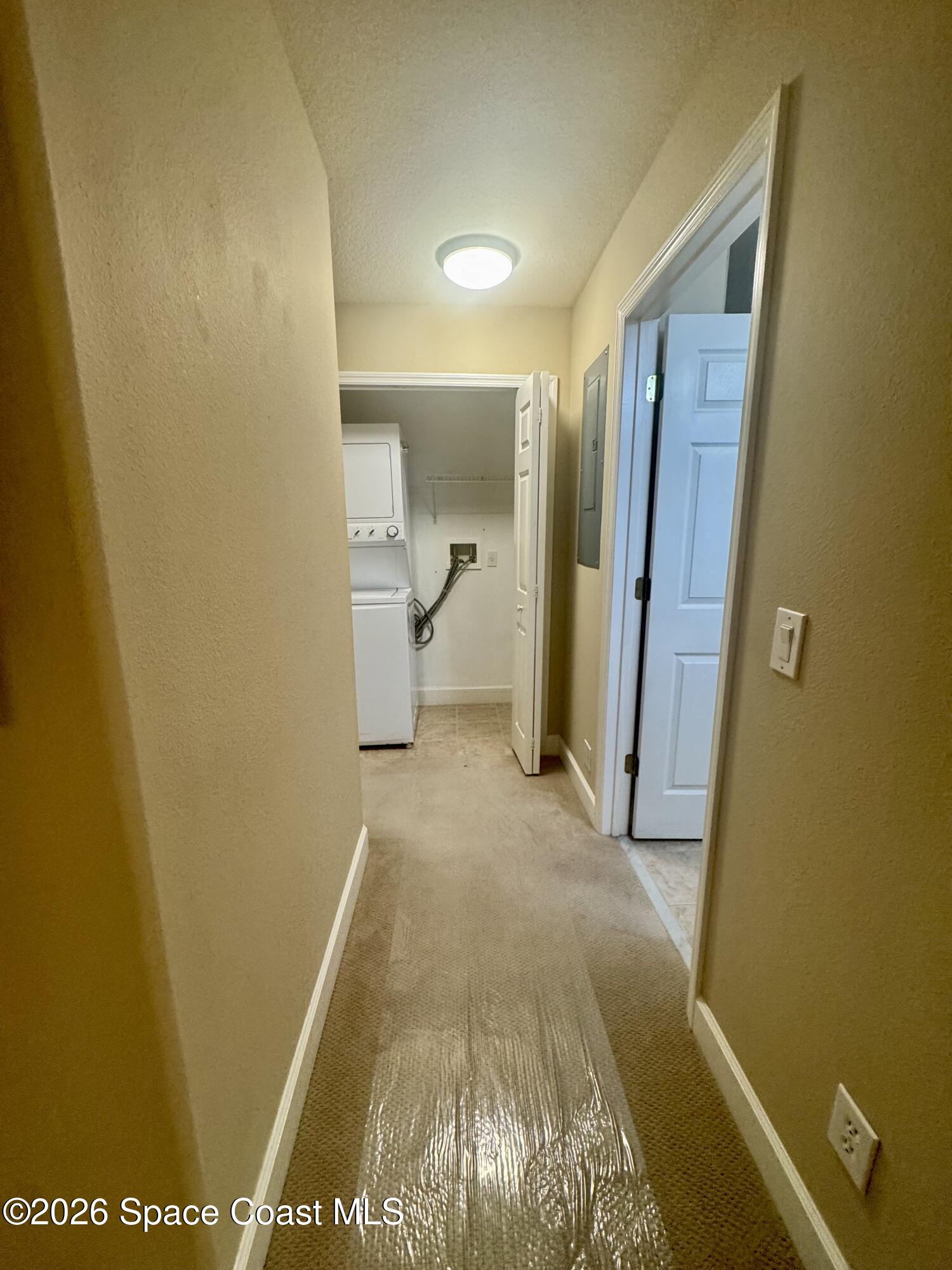 4575 Radiant Way, Unit 102 Melbourne, FL 32901 - Photo 45 of 73 a view of a hallway with wooden floor