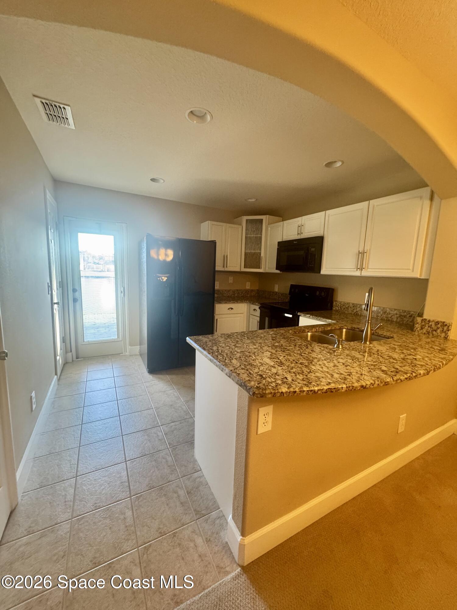 4575 Radiant Way, Unit 102 Melbourne, FL 32901 - Photo 46 of 73 a view of kitchen with granite countertop sink and stove