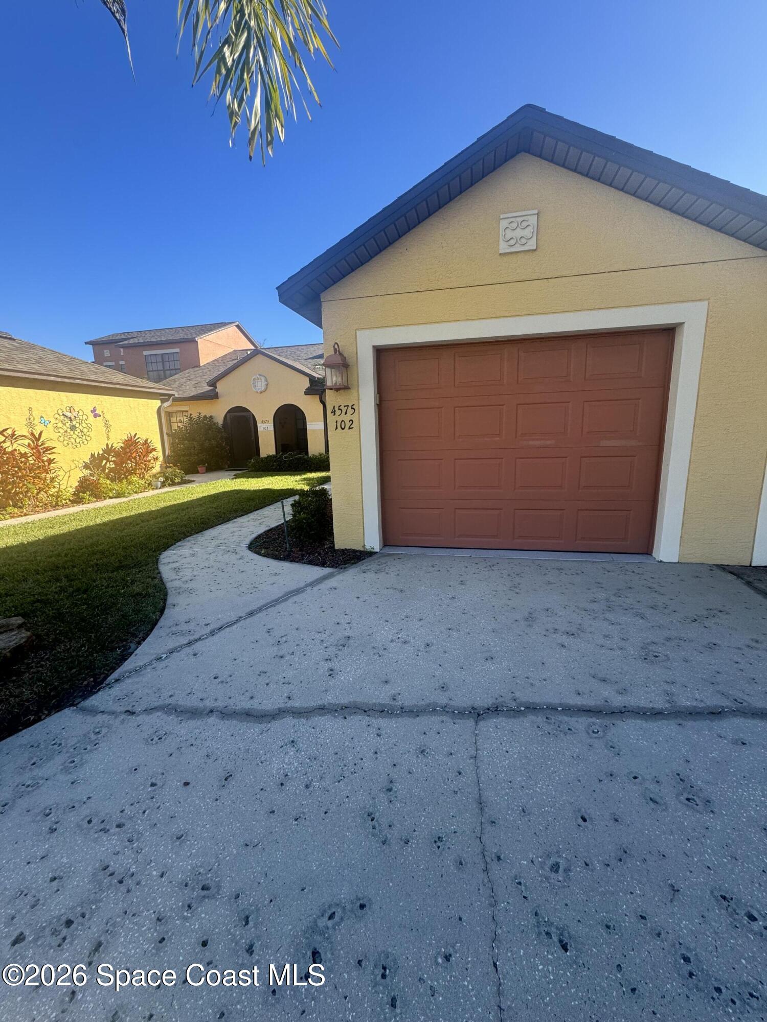 4575 Radiant Way, Unit 102 Melbourne, FL 32901 - Photo 5 of 73 a front view of a house with a yard