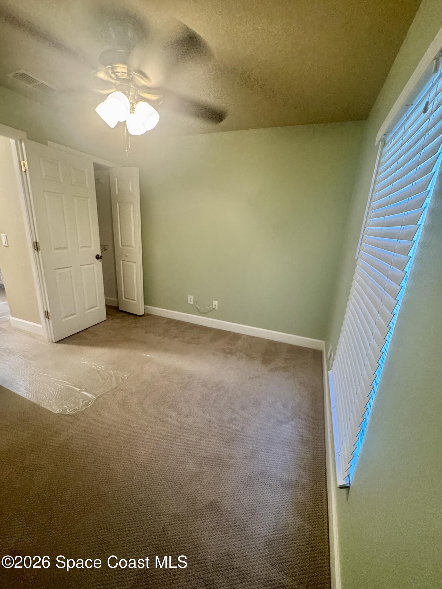 4575 Radiant Way, Unit 102 Melbourne, FL 32901 - Photo 52 of 73 a view of an empty room with wooden floor