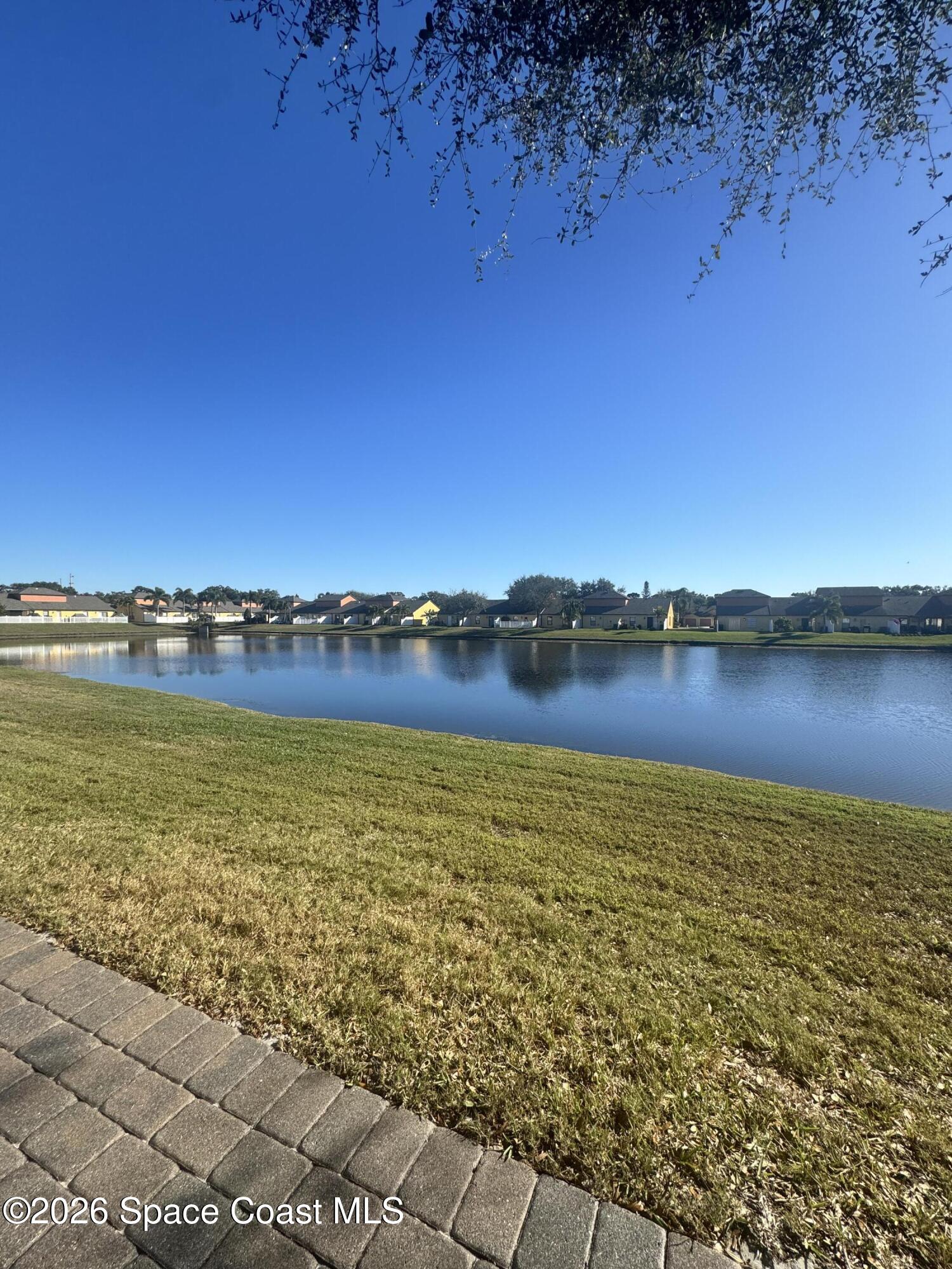 4575 Radiant Way, Unit 102 Melbourne, FL 32901 - Photo 68 of 73 a view of a lake with houses in the background