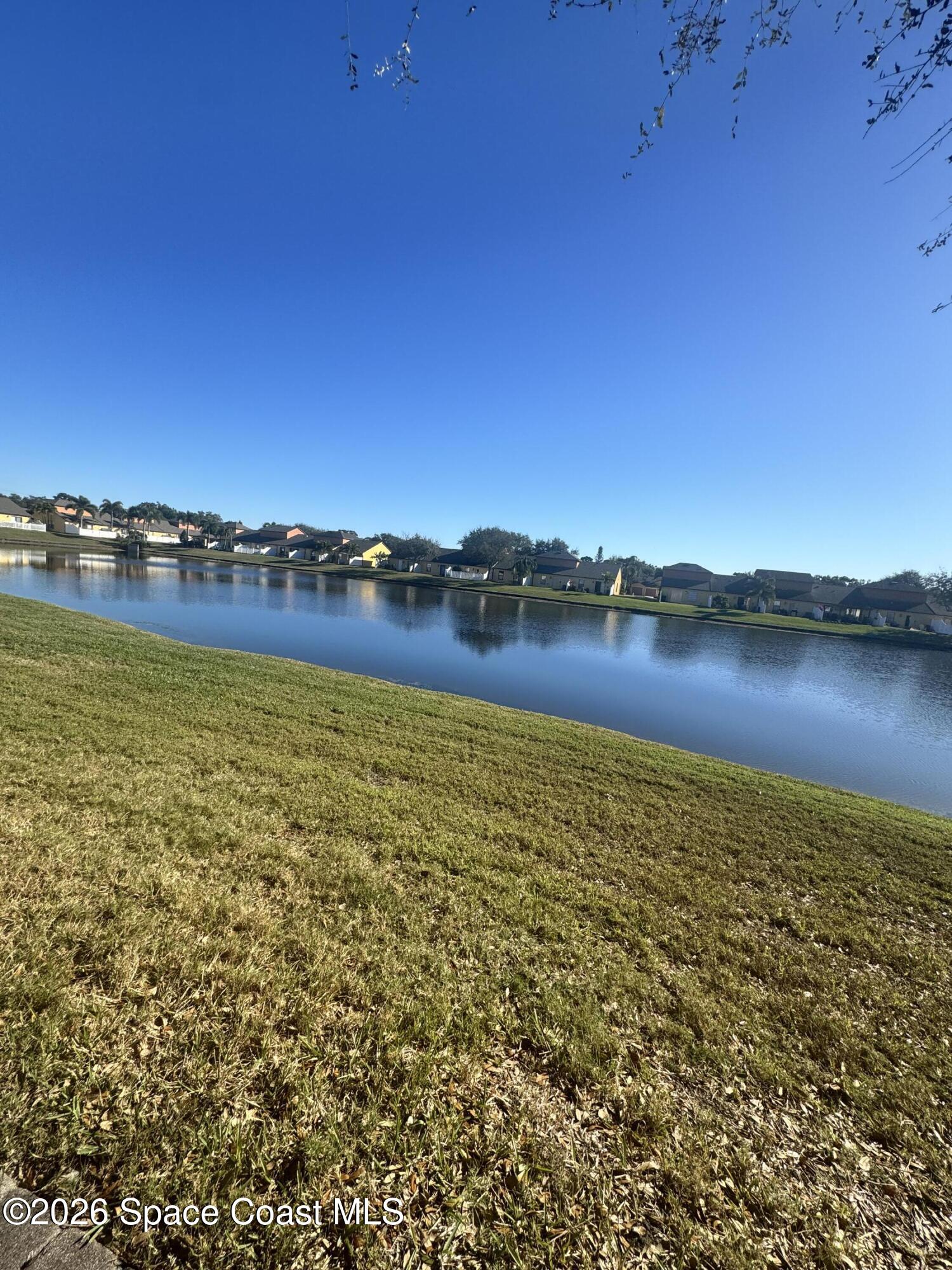 4575 Radiant Way, Unit 102 Melbourne, FL 32901 - Photo 73 of 73 a view of a lake with houses in the background