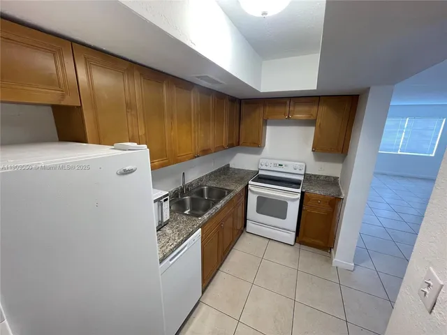 a kitchen with granite countertop cabinets and steel stainless steel appliances