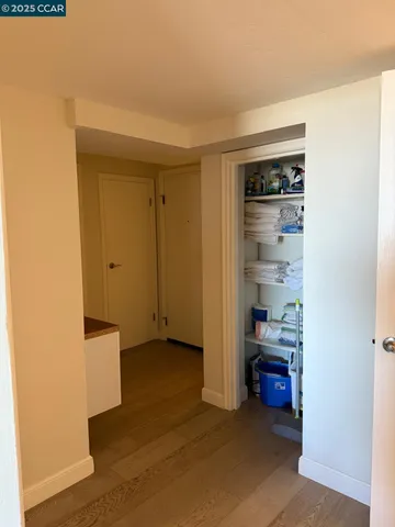 a view of empty room with closet and wooden floor
