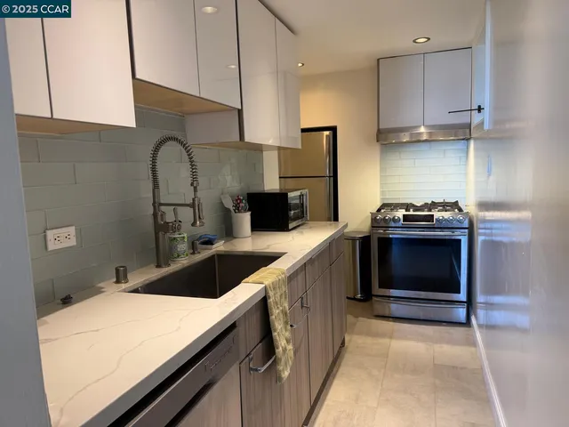 a kitchen with a sink and a stove top oven