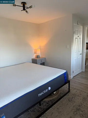 a bed sitting in a bedroom and table