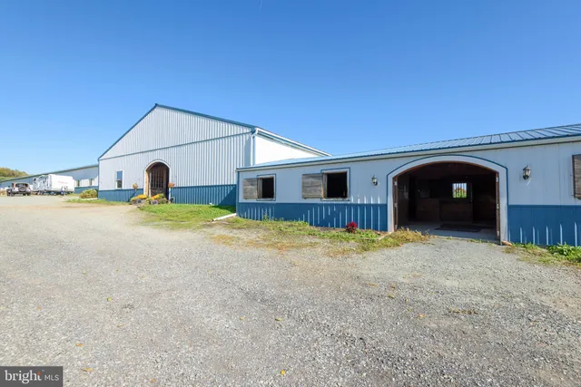 an aerial view of a house with swimming pool patio and outdoor seating