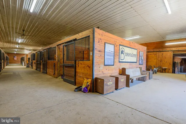 a kitchen with a dining table chairs stainless steel appliances and cabinets