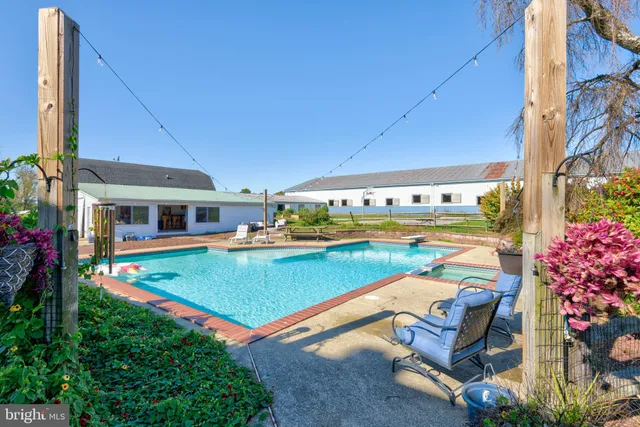 a bathroom with a sink a large mirror and a bathtub