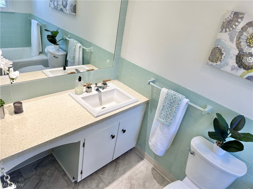6130 Renninger Road New Franklin, OH 44319 - Photo 12 of 30 Full Bathroom with new LV tile floors, and toilet