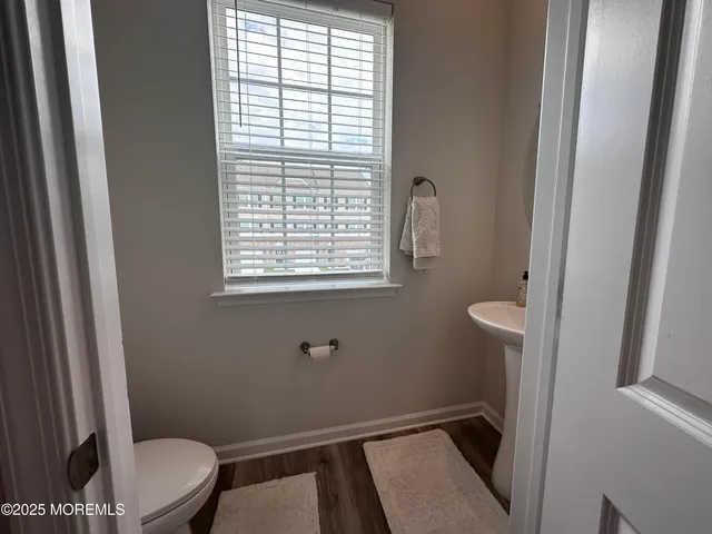 a bathroom with a window a toilet and a sink