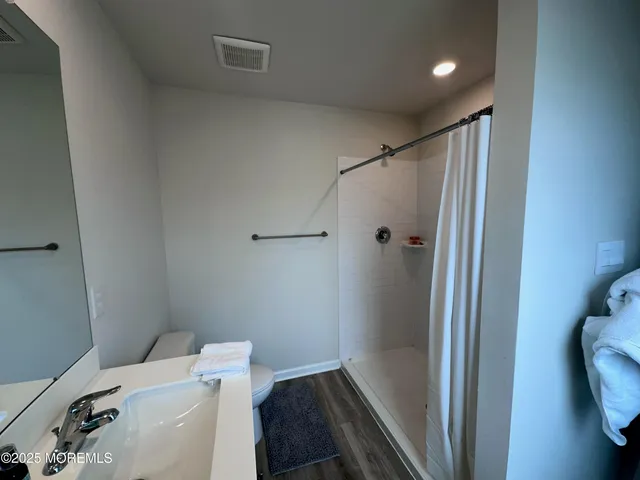 a bathroom with a shower toilet and sink
