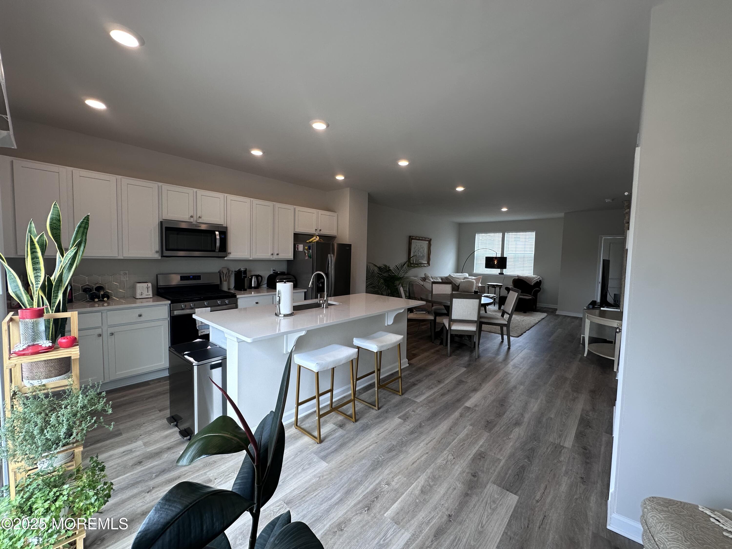 248 Macoun Way Glassboro, NJ 08028 - Photo 7 of 18 a living room with furniture and a dining table with kitchen view