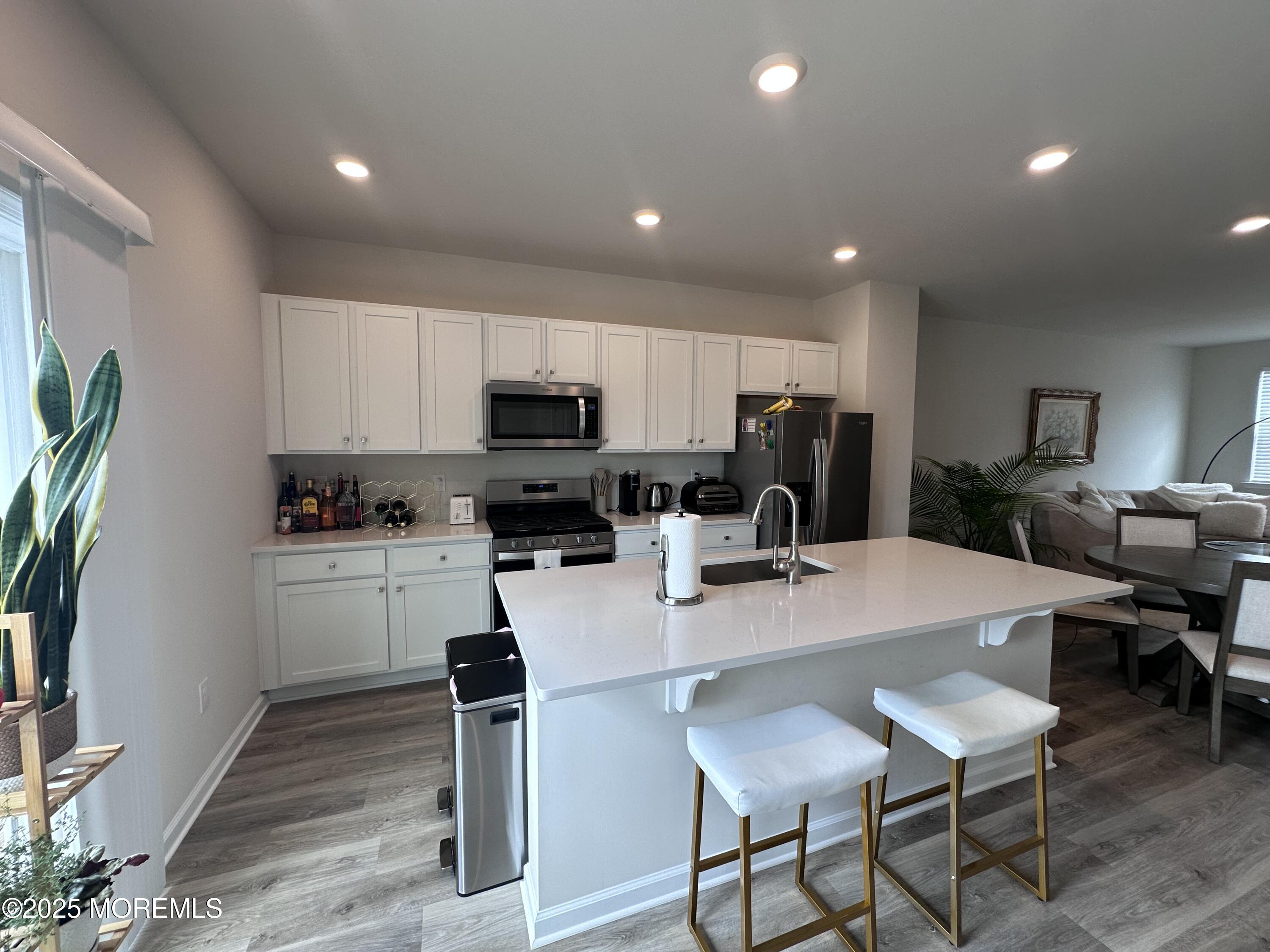 248 Macoun Way Glassboro, NJ 08028 - Photo 8 of 18 a kitchen with sink a refrigerator and chairs