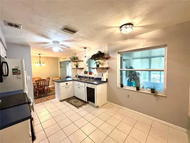 a large white kitchen with a large window