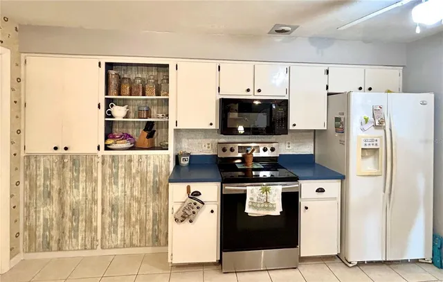 a kitchen with stainless steel appliances a refrigerator a stove and a cabinets