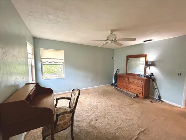 a bedroom with furniture and a window