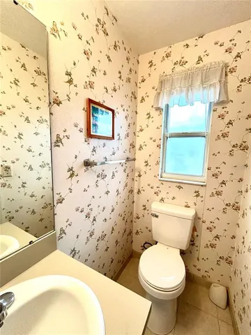 a bathroom with a toilet and a shower curtain