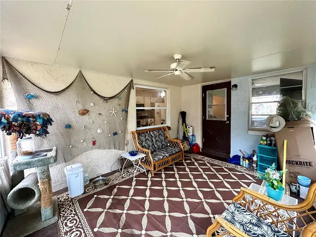a living room with furniture a rug and a chandelier