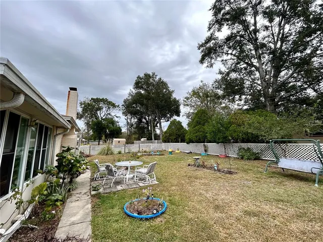 a view of a swimming pool with a patio and fire pit