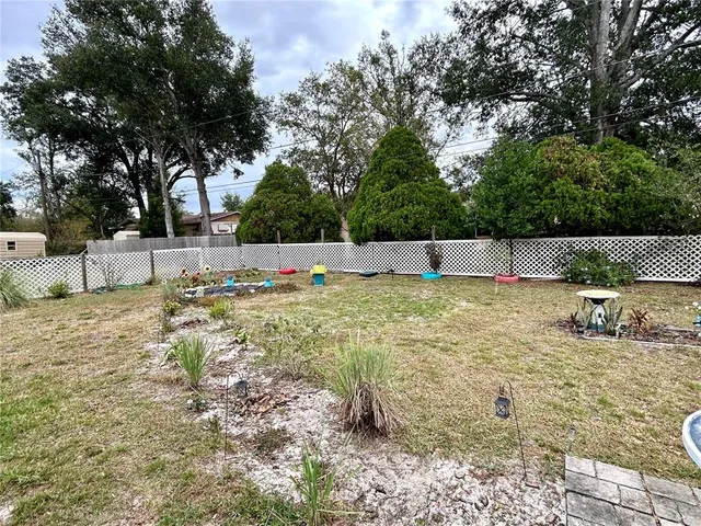 a swimming pool with outdoor seating and yard
