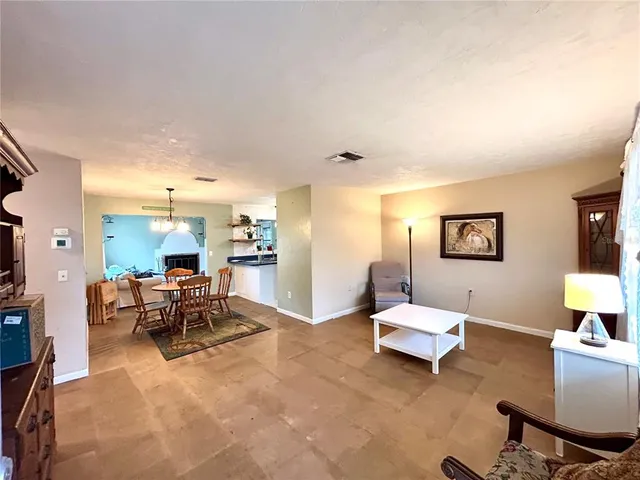 a living room with furniture and a dining room