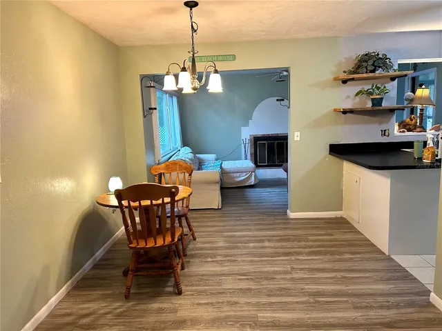 a view of a dining room with furniture wooden floor and a chandelier