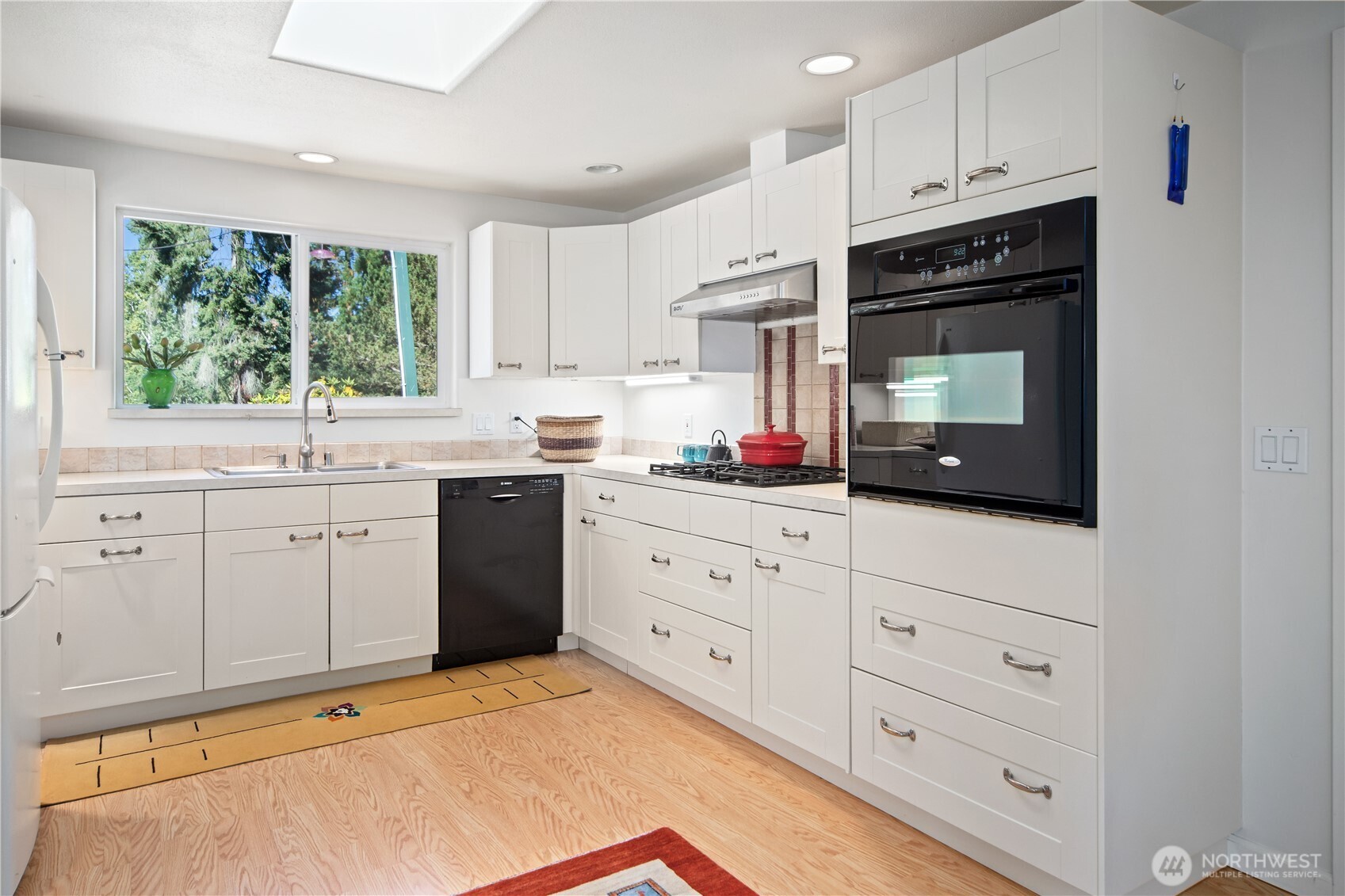 245 Gupster Road Sequim, WA 98382 - Photo 11 of 40 a kitchen with granite countertop white cabinets and white appliances
